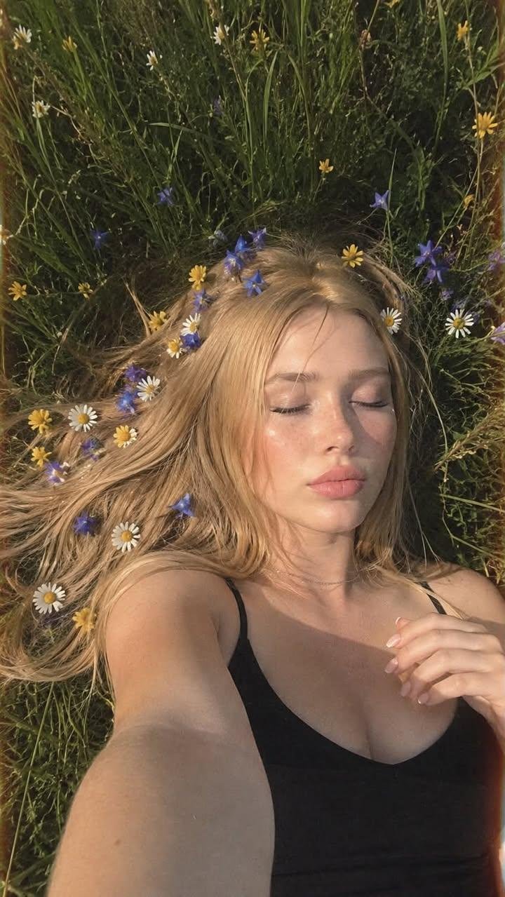 Relaxed Blonde Lying in Wildflowers with Flowers in