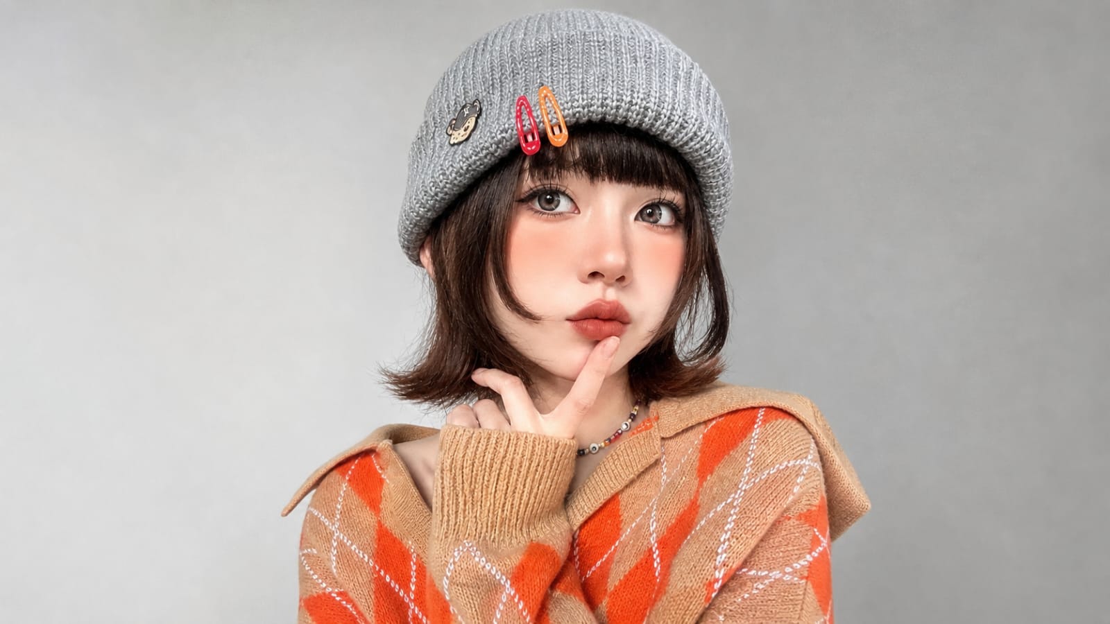 Cute young woman in argyle sweater and beanie
