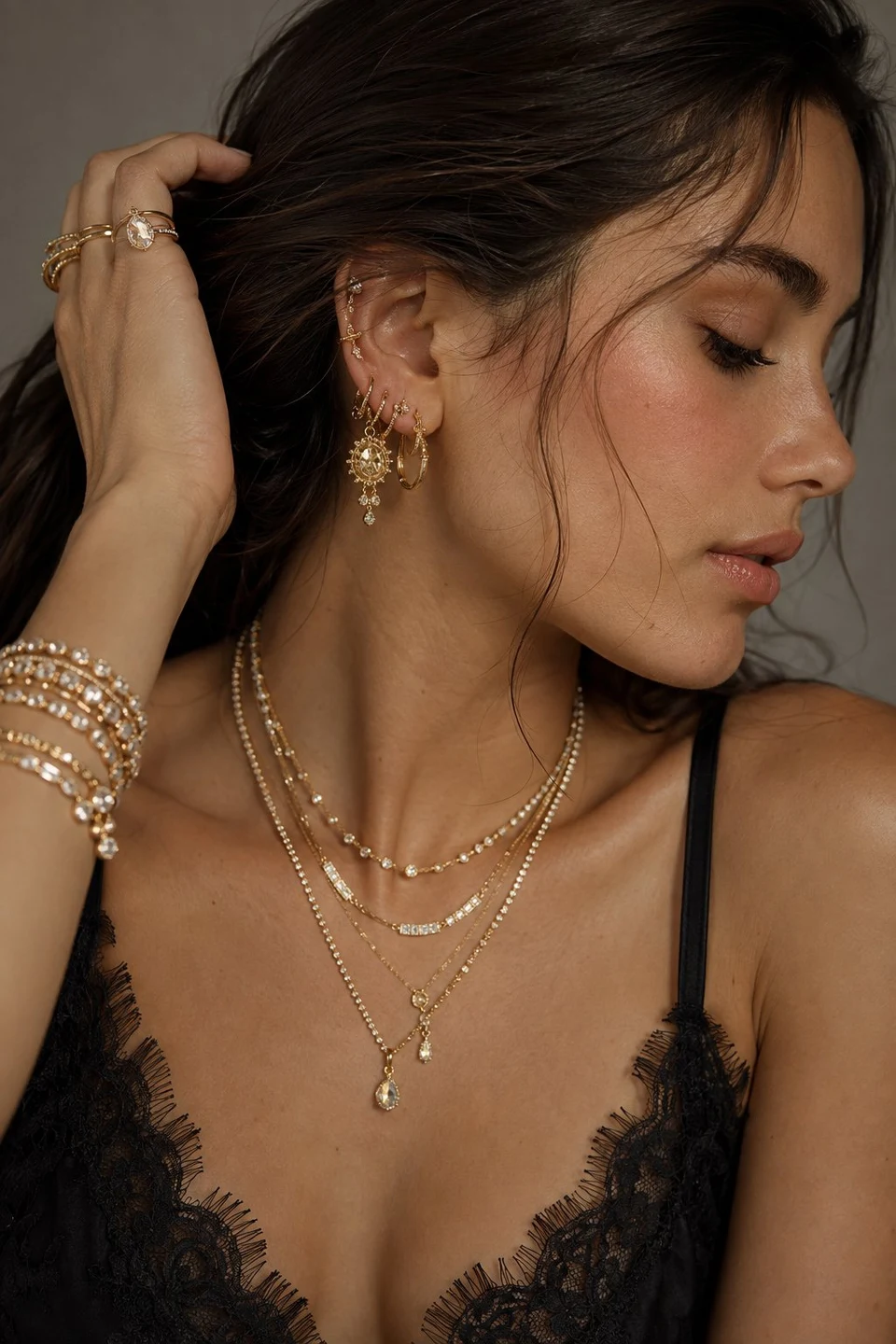 Elegant woman displaying layered gold jewelry