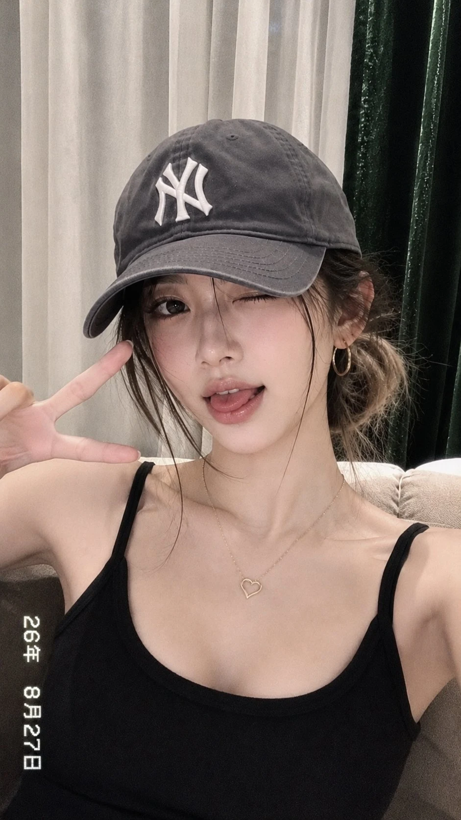 East Asian woman wearing baseball cap making playful