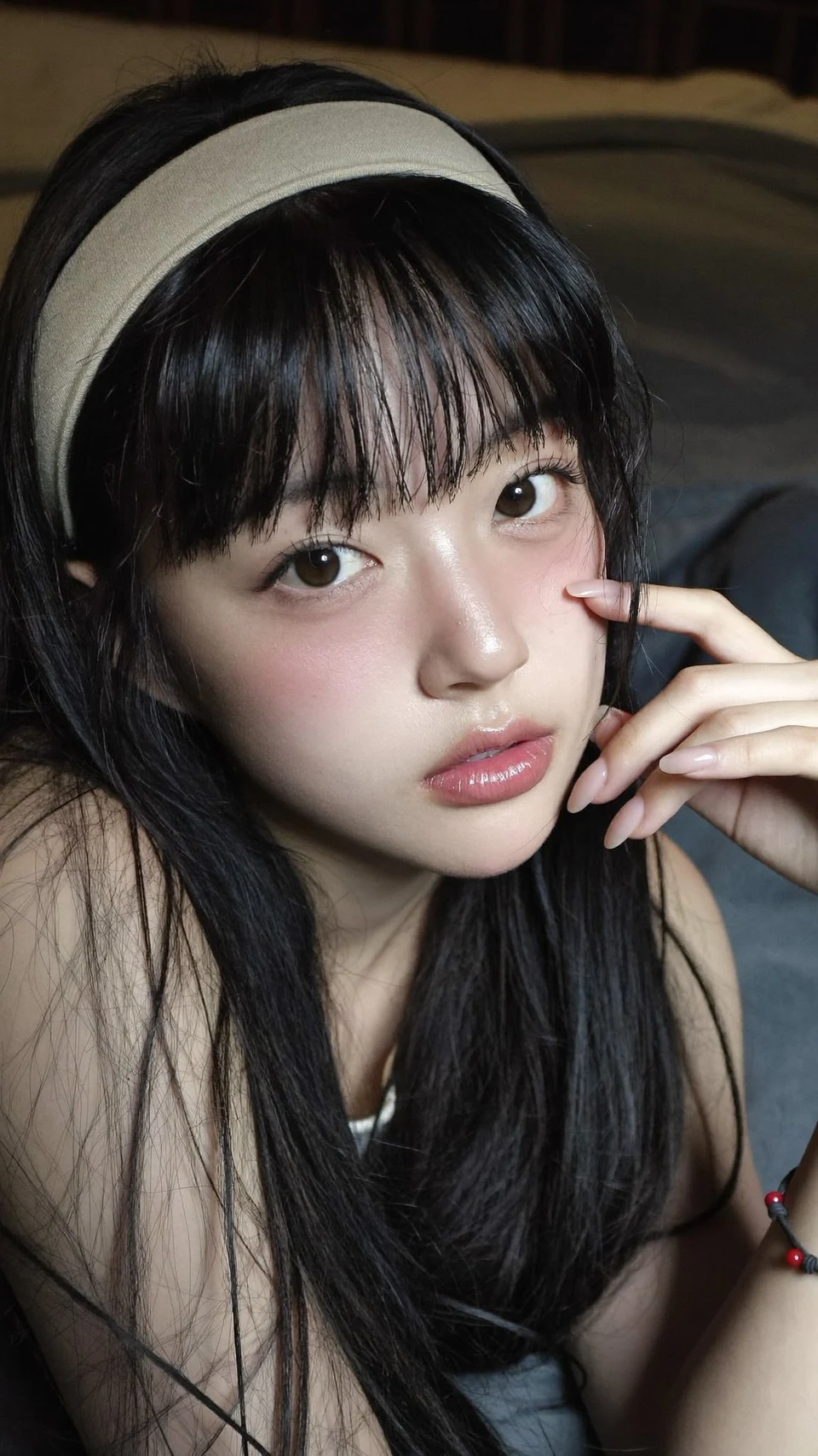 Intimate portrait of young East Asian woman lying on