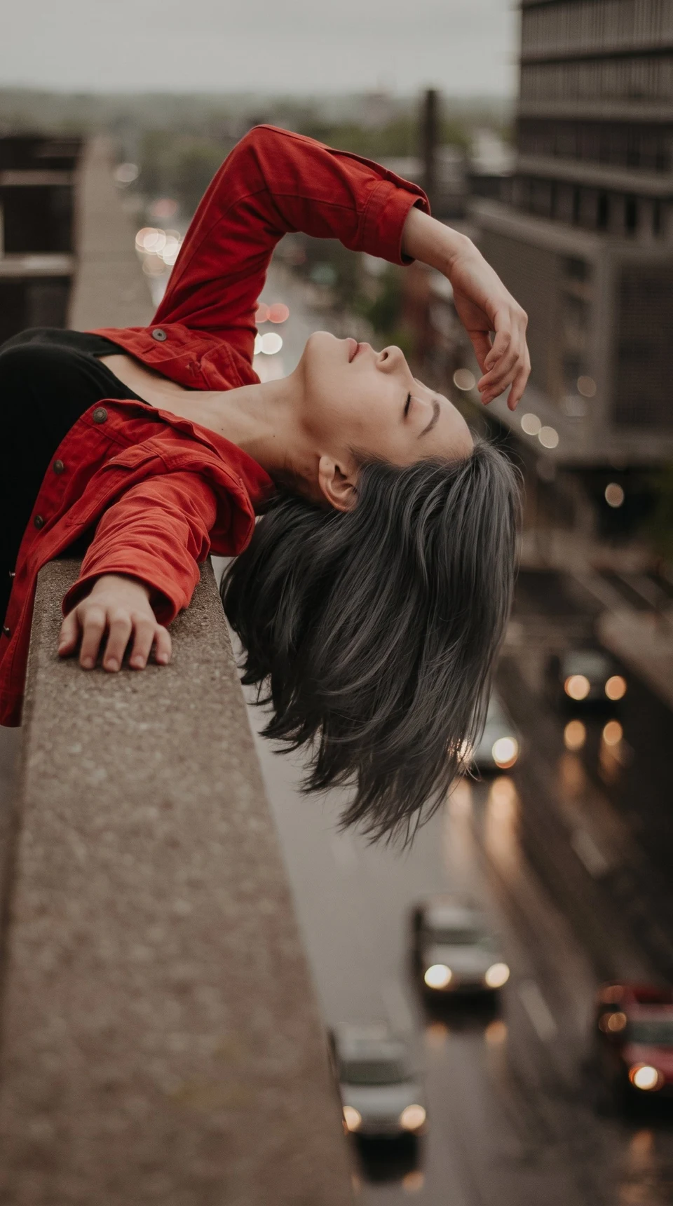 woman leaning back over rooftop ledge
