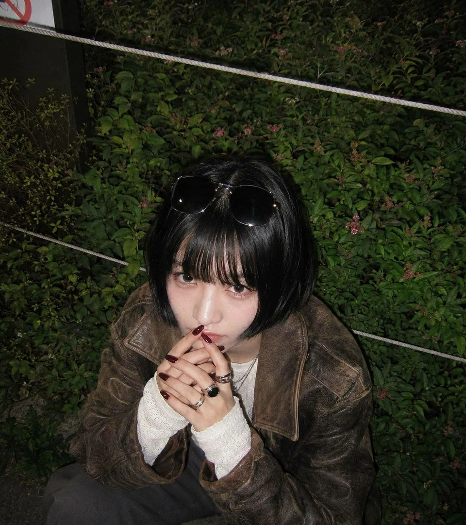 woman in brown leather jacket with flash photography