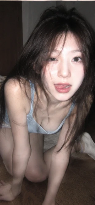 Young woman in denim bralette crouching low to