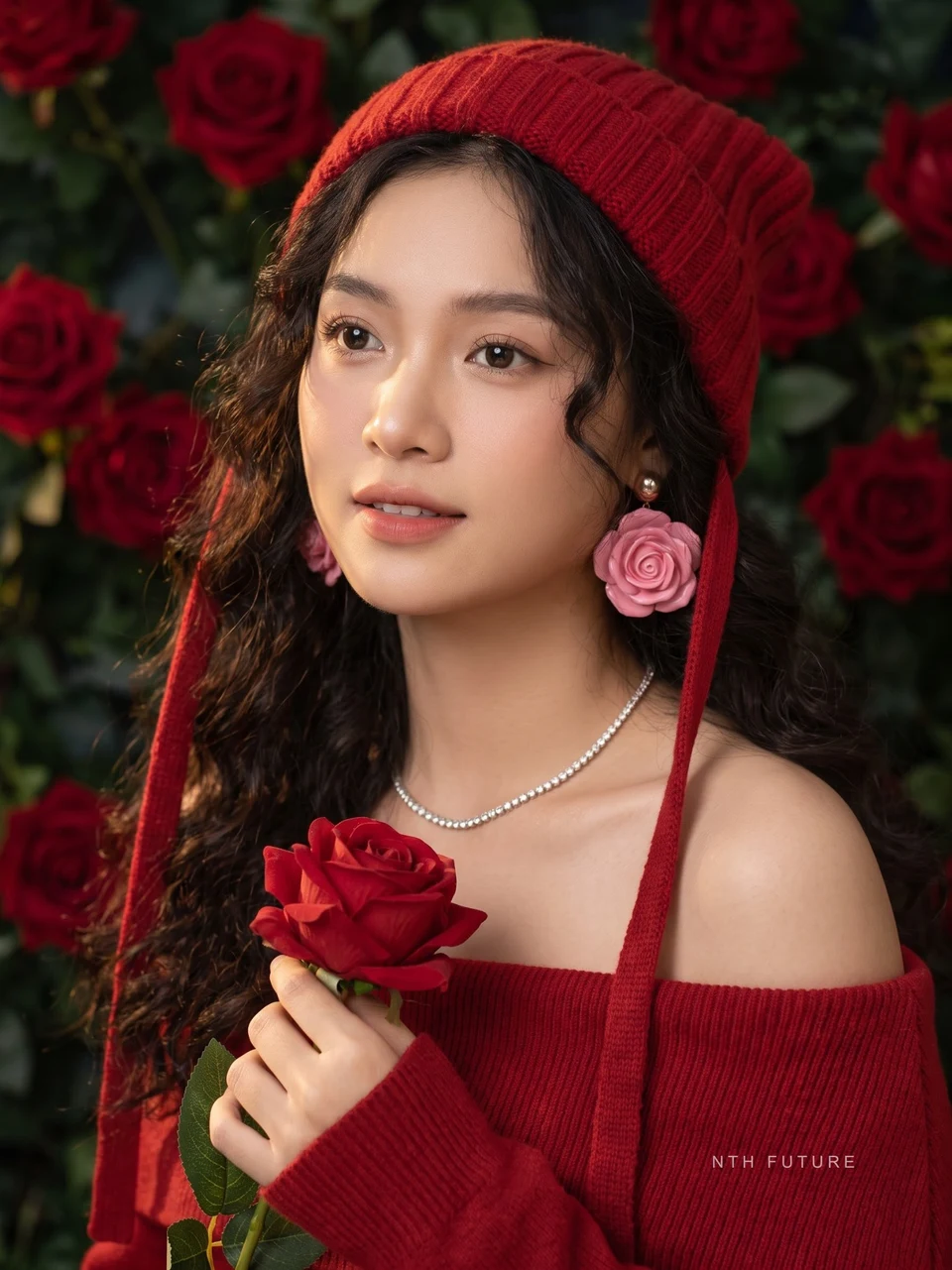 Vietnamese woman holding red rose wearing red beanie
