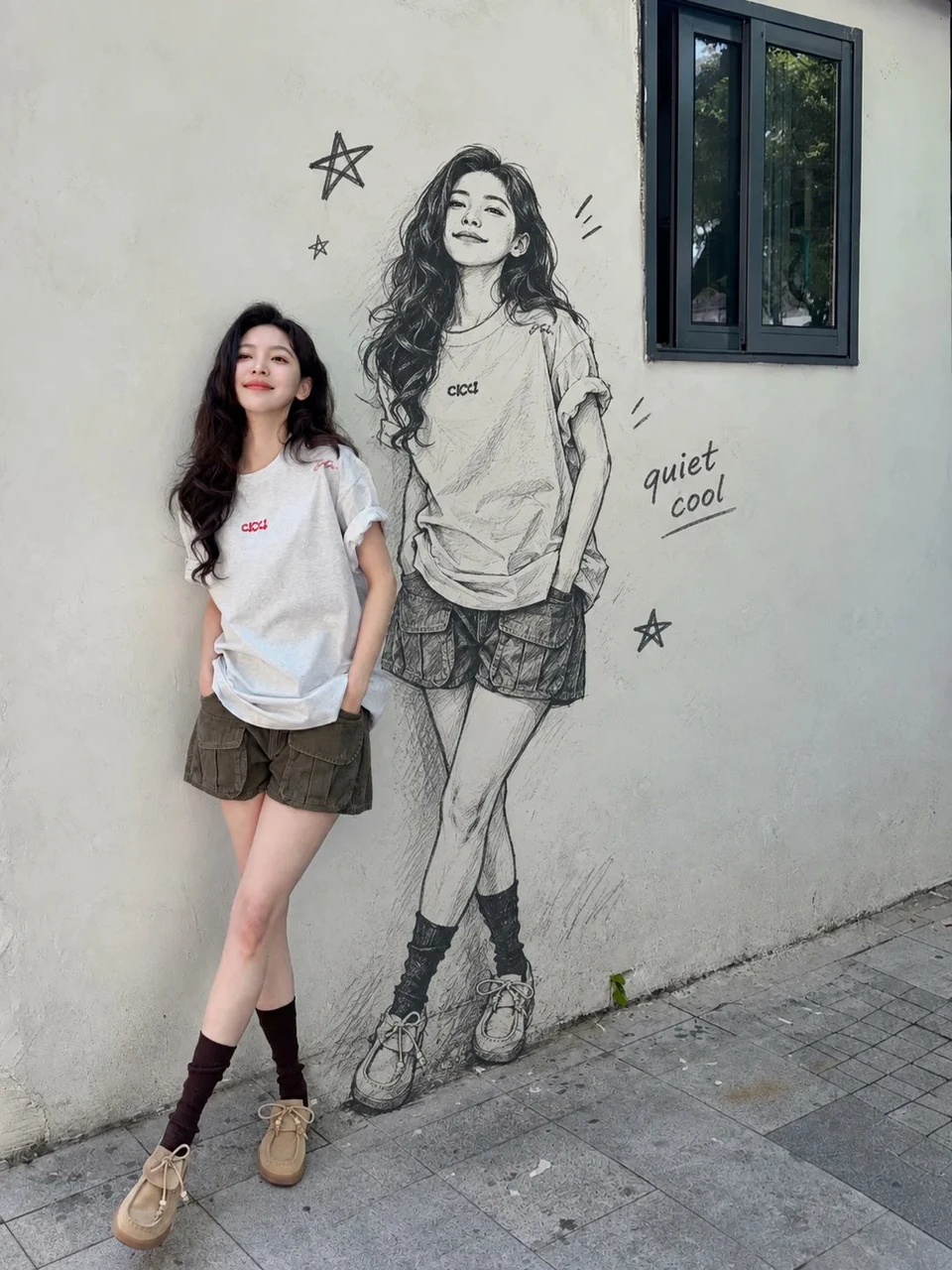 Young Woman Posing Beside Monochrome Manga Wall