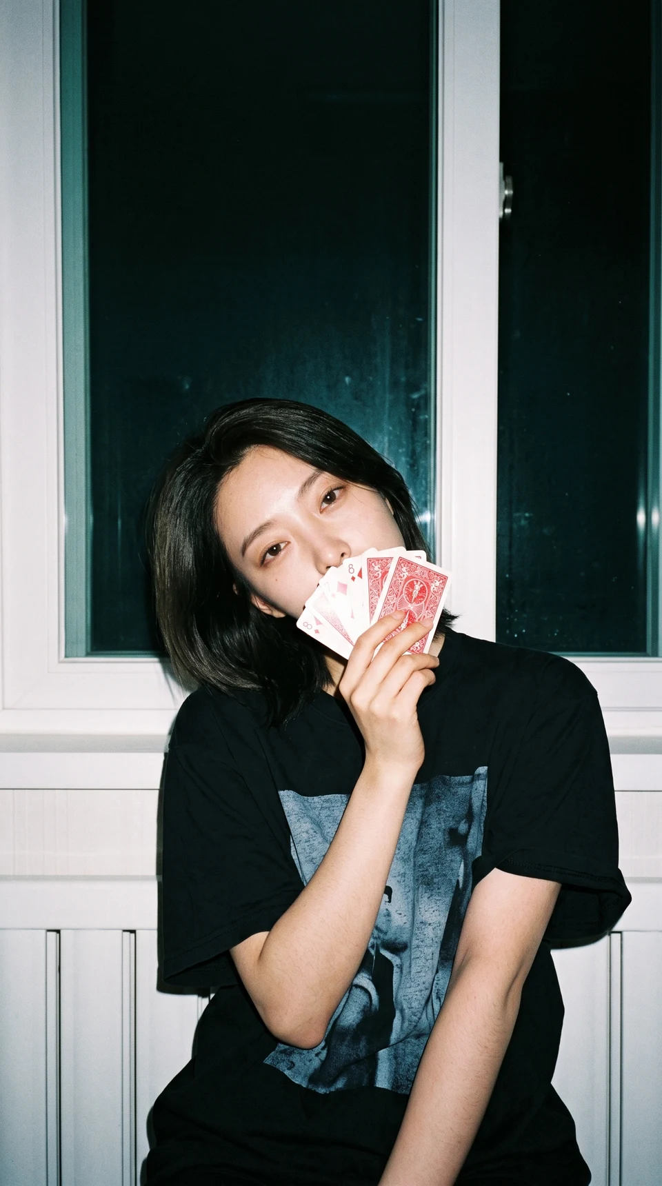 Portrait of young woman with card fan