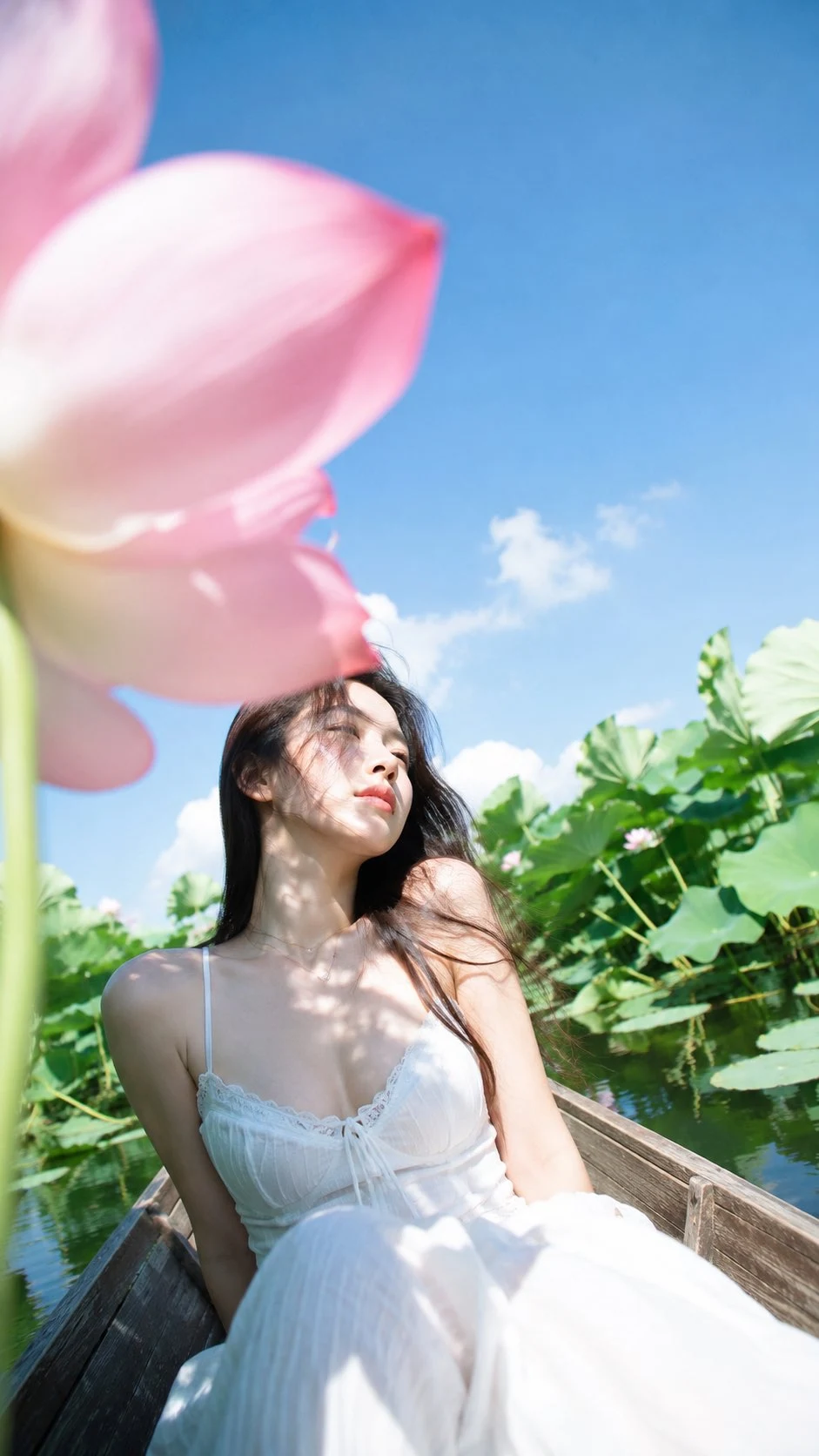 Korean woman on lotus pond boat