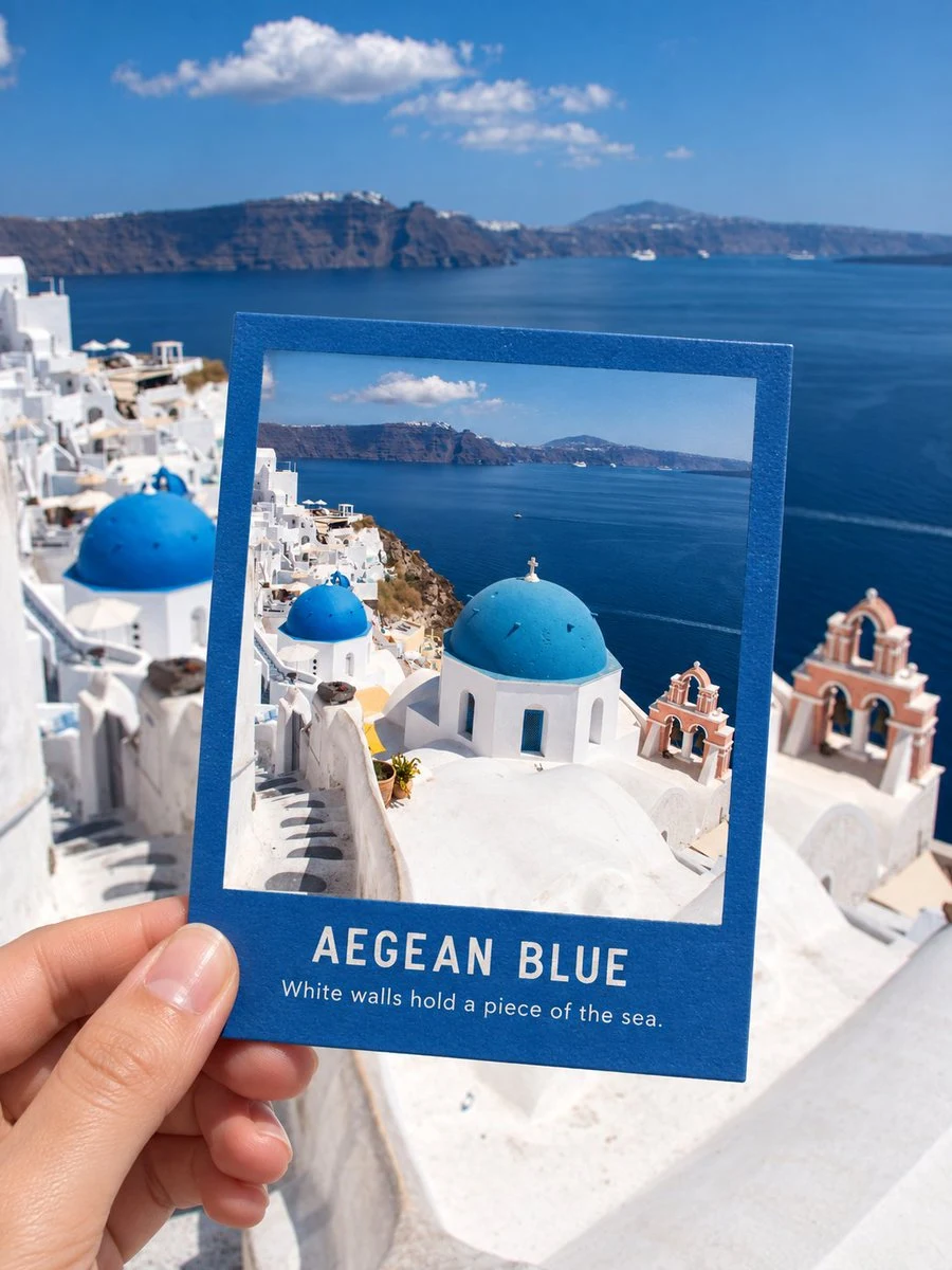 polaroid held against santorini oia view